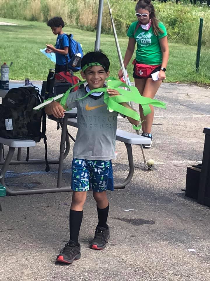 Camper playing outside at Swim&Gym Summer Camp