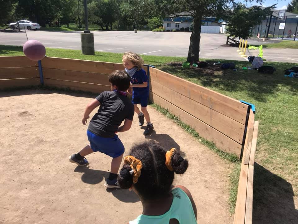 Camper playing in the wooden GaGa pit