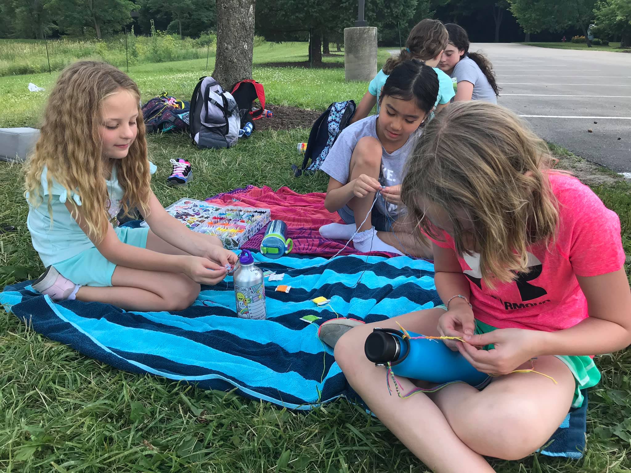 Campers making bracelets together during craft time