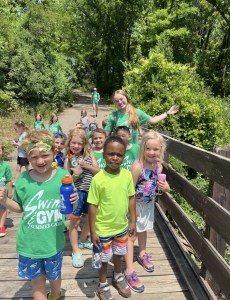 Campers hiking together on a wooded trail