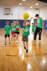 Campers playing basketball in the indoor gym
