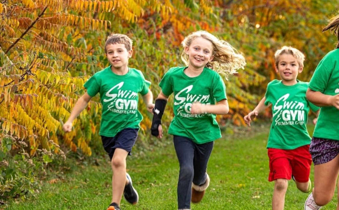 Campers in Swim&Gym t-shirts running outdoors together