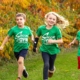 Campers in Swim&Gym t-shirts running outdoors together